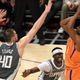 Chris Paul of the Phoenix Suns shoots against Ivica Zubac and Reggie Jackson of the LA Clippers.